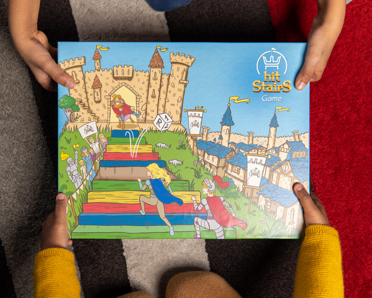 Une famille rassemblée autour d'un jeu HIT STAIRS